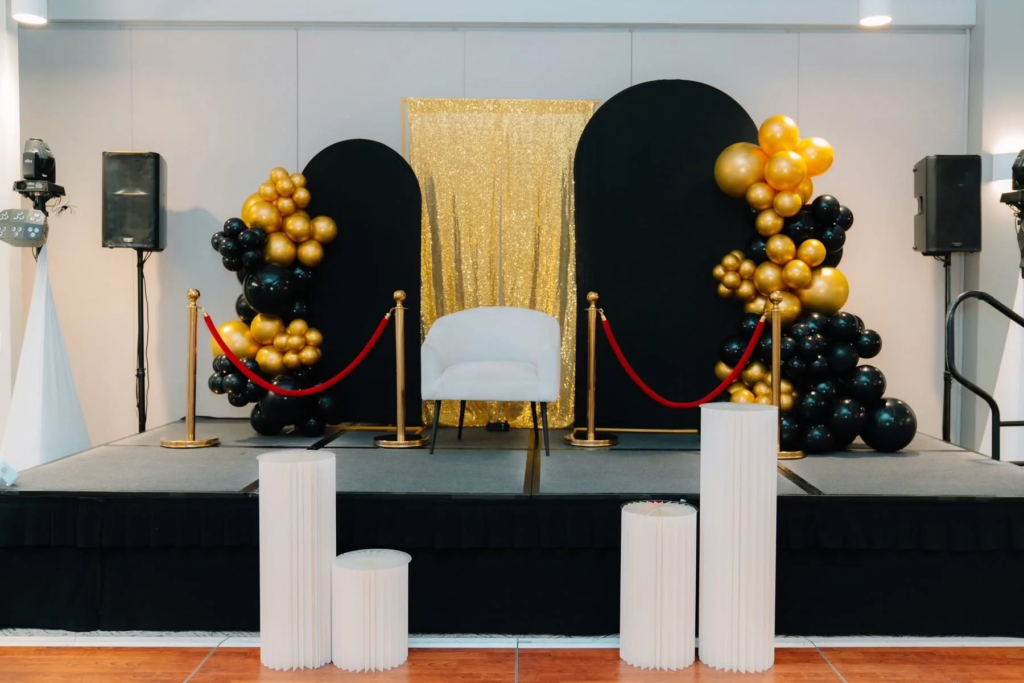 HK Creative Events - black and gold balloon stage backdrop